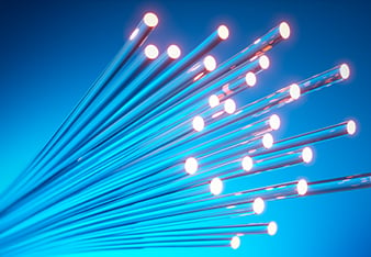 Close up of fiber optics cable with light effects and blue background